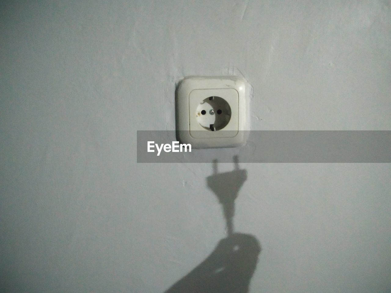 CLOSE-UP OF ELECTRIC FAN ON WALL