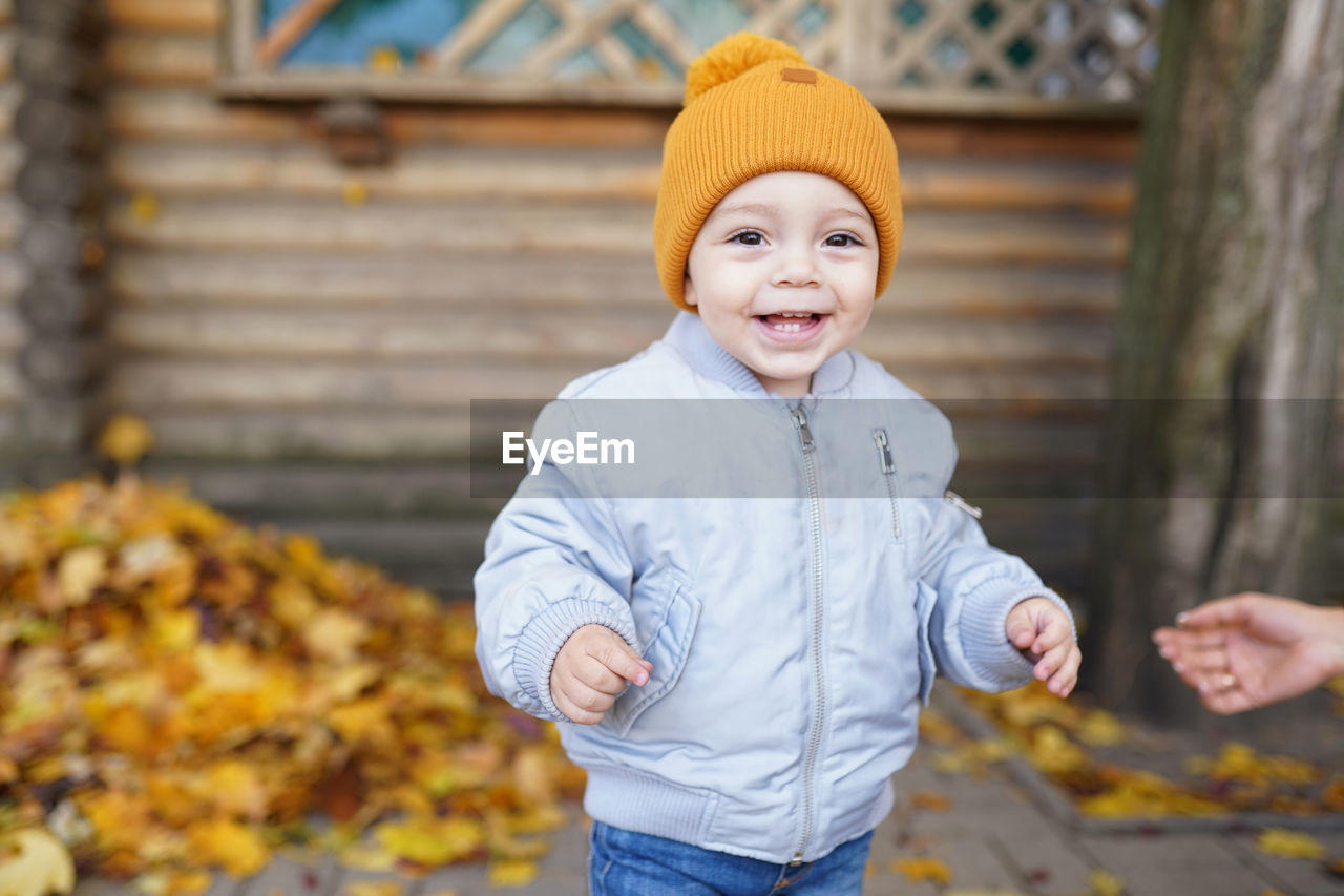 PORTRAIT OF SMILING BOY WEARING MASK