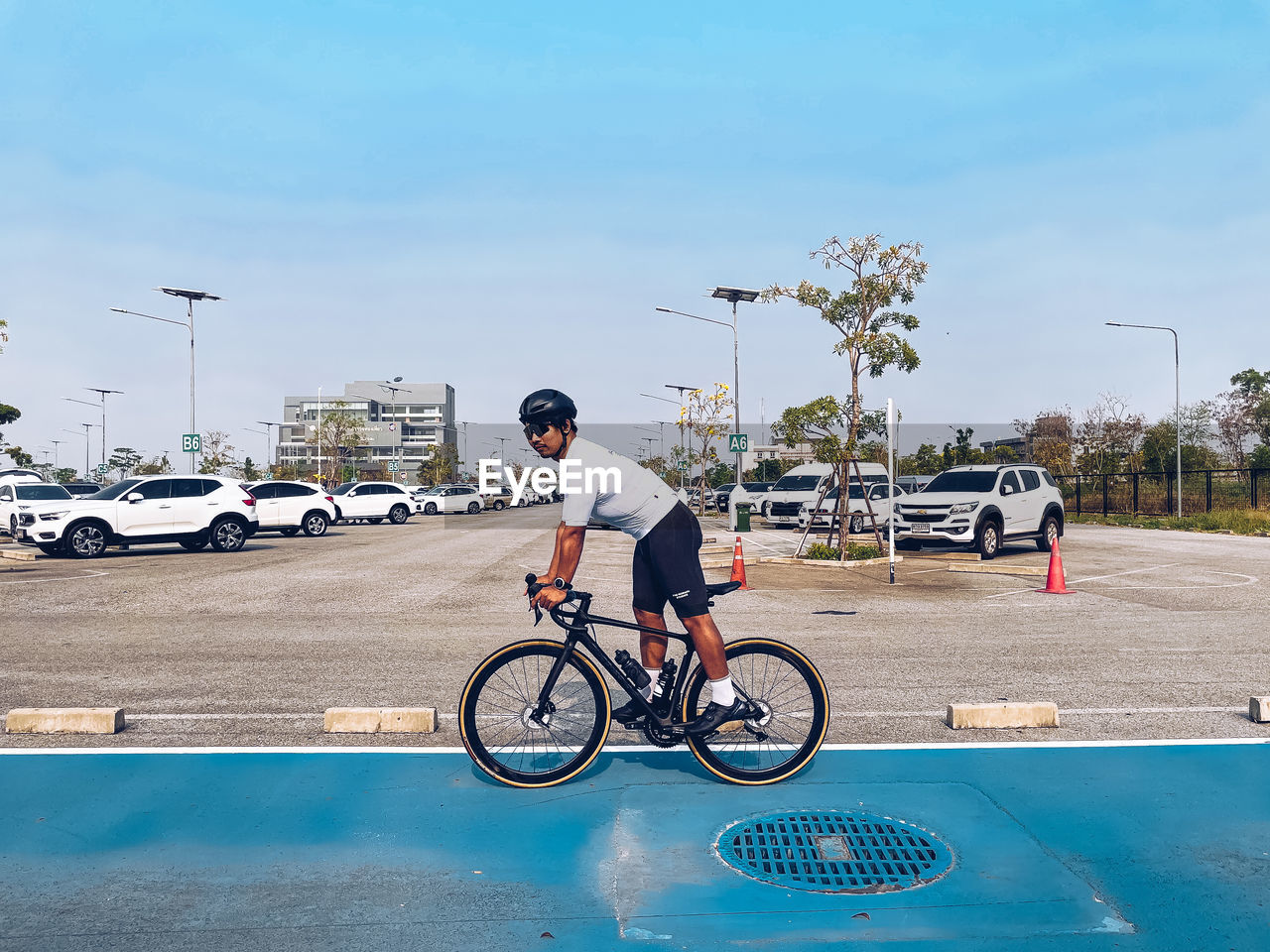 MAN RIDING BICYCLE ON ROAD