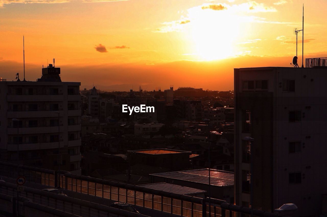 Cityscape against sky during sunset