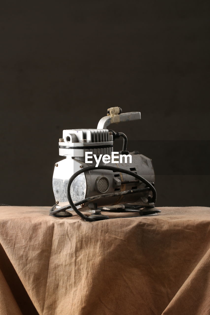 CLOSE-UP OF MACHINE PART ON TABLE
