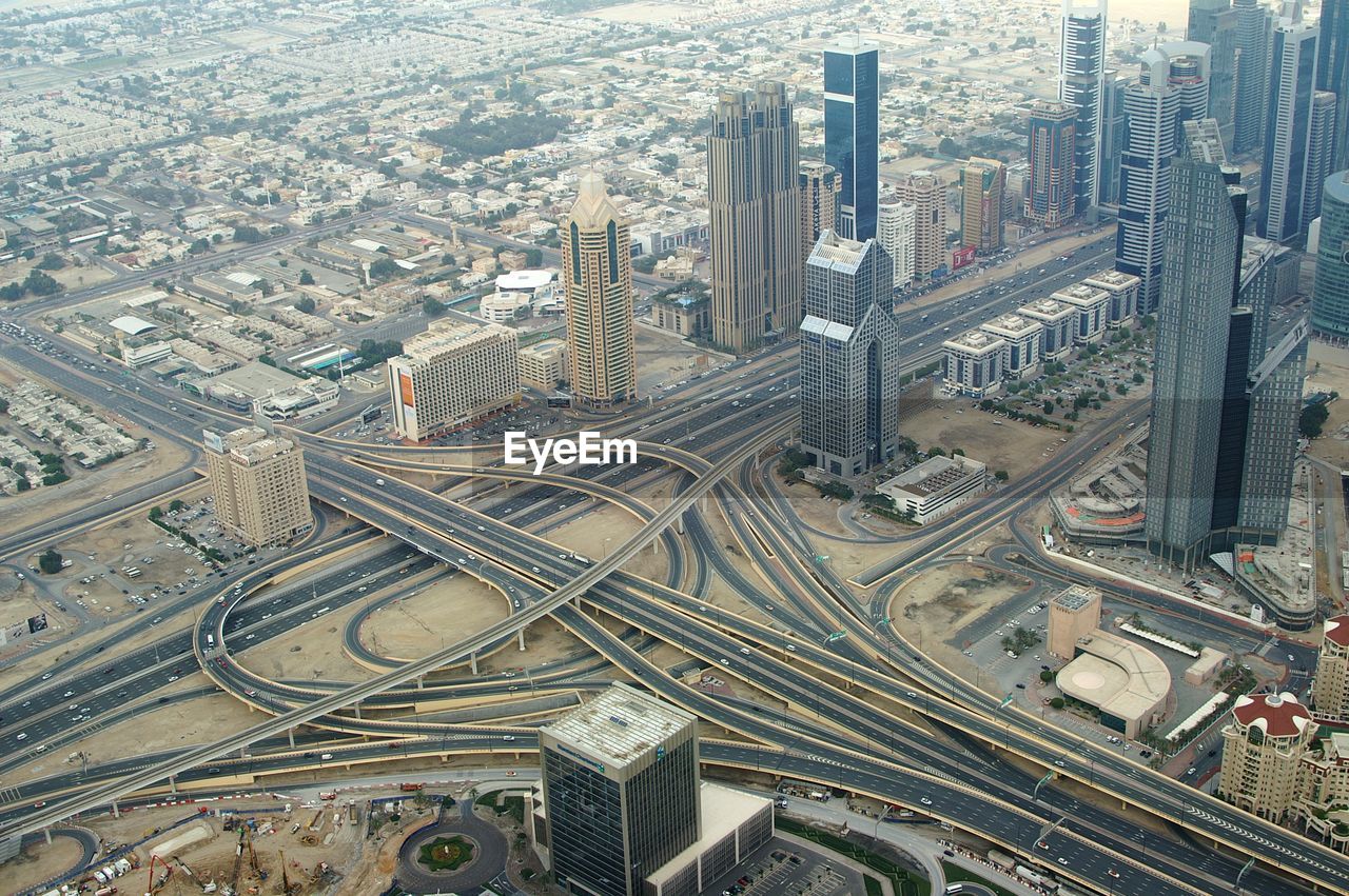 Aerial view of road intersection and modern buildings in city