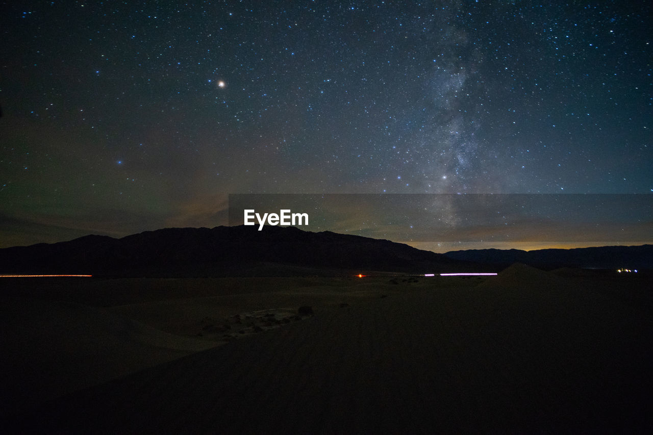 Scenic view of lake against sky at night