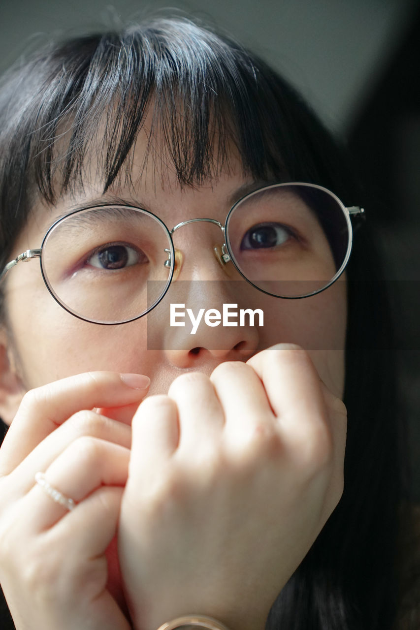 eyeglasses, vision care, glasses, close-up, portrait, nose, human face, one person, child, human eye, person, childhood, human head, headshot, skin, looking at camera, indoors, human mouth, hand, women, emotion, female, adult, eyewear, smiling, looking, cute, front view
