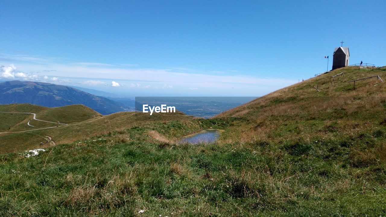 SCENIC VIEW OF GRASSY FIELD AGAINST SKY