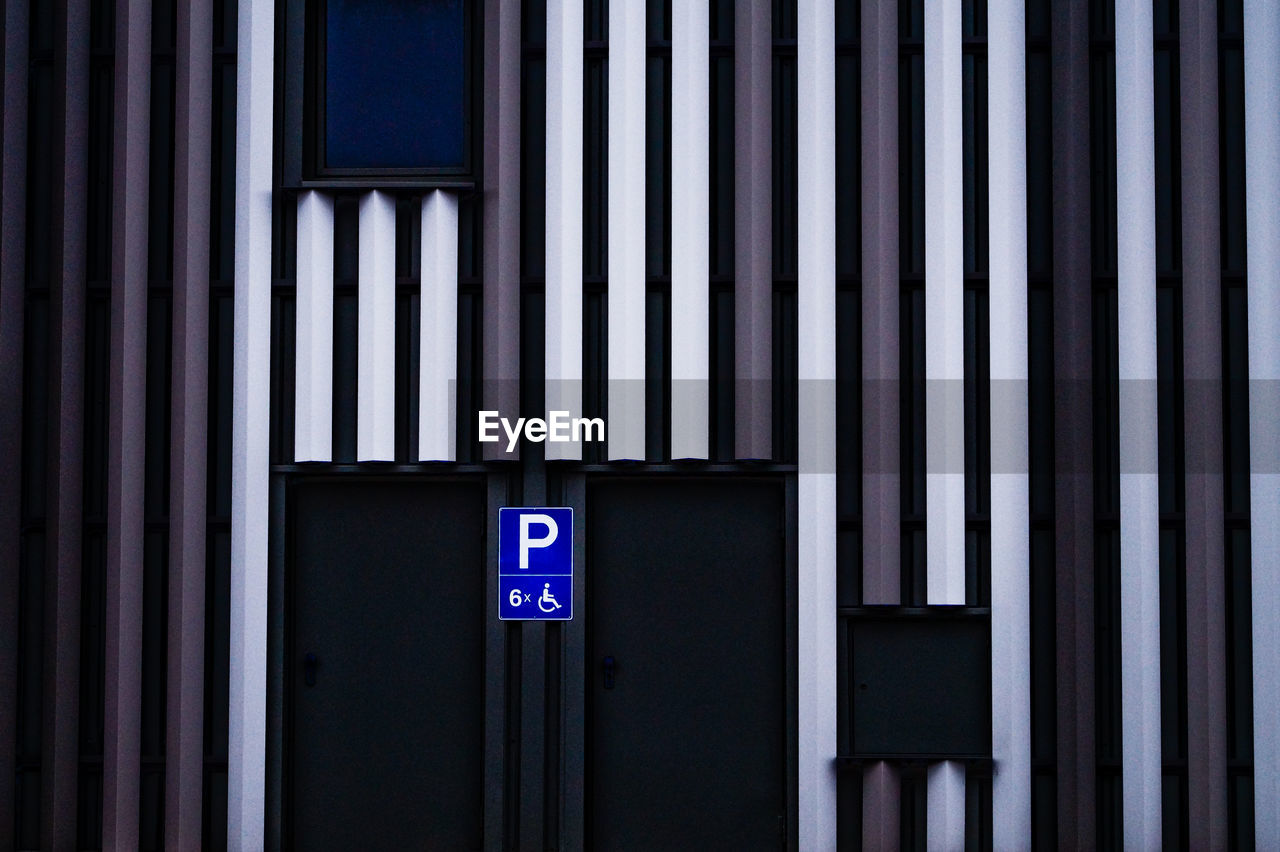 Disabled parking sign on wall