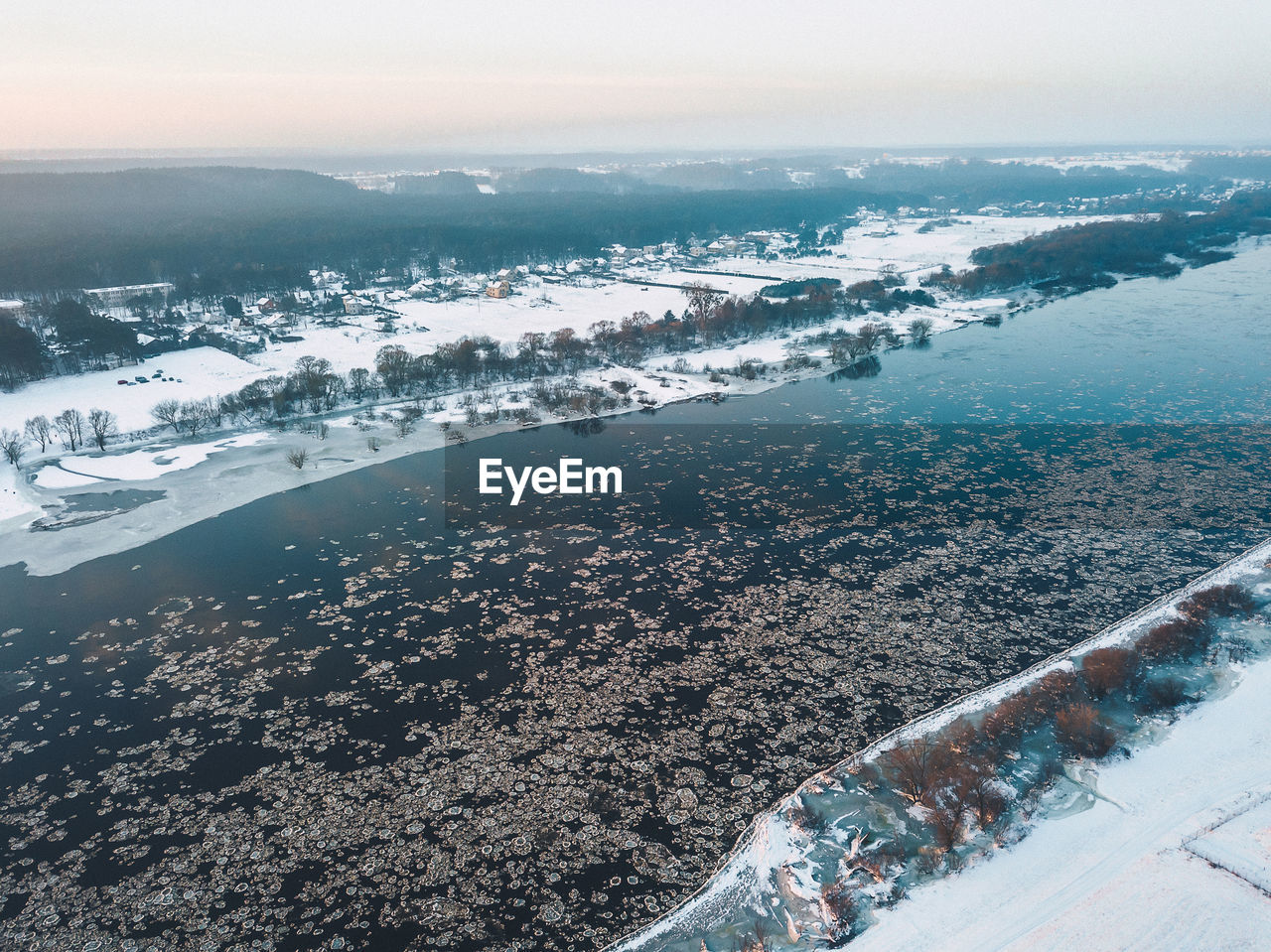 HIGH ANGLE VIEW OF FROZEN RIVER AGAINST SKY