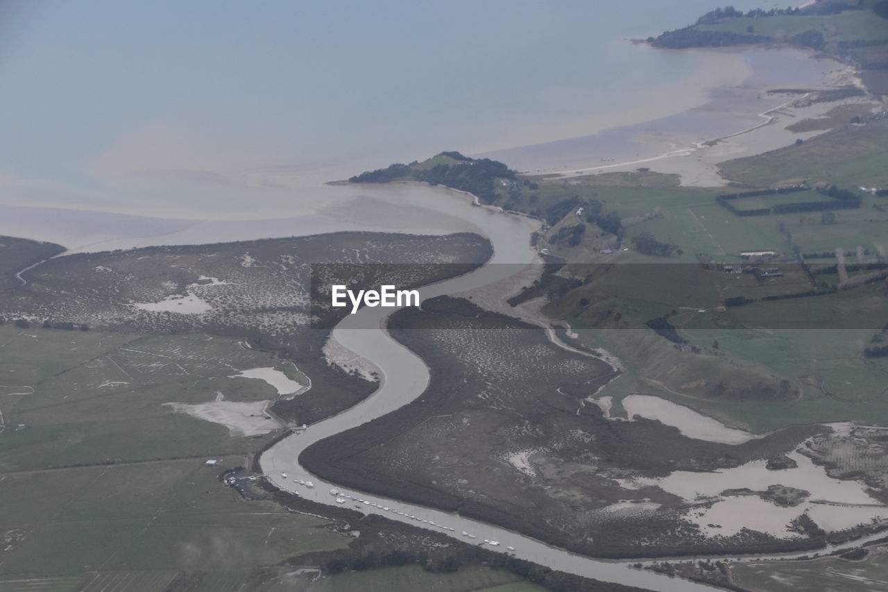 Aerial view of river amidst landscape against sky