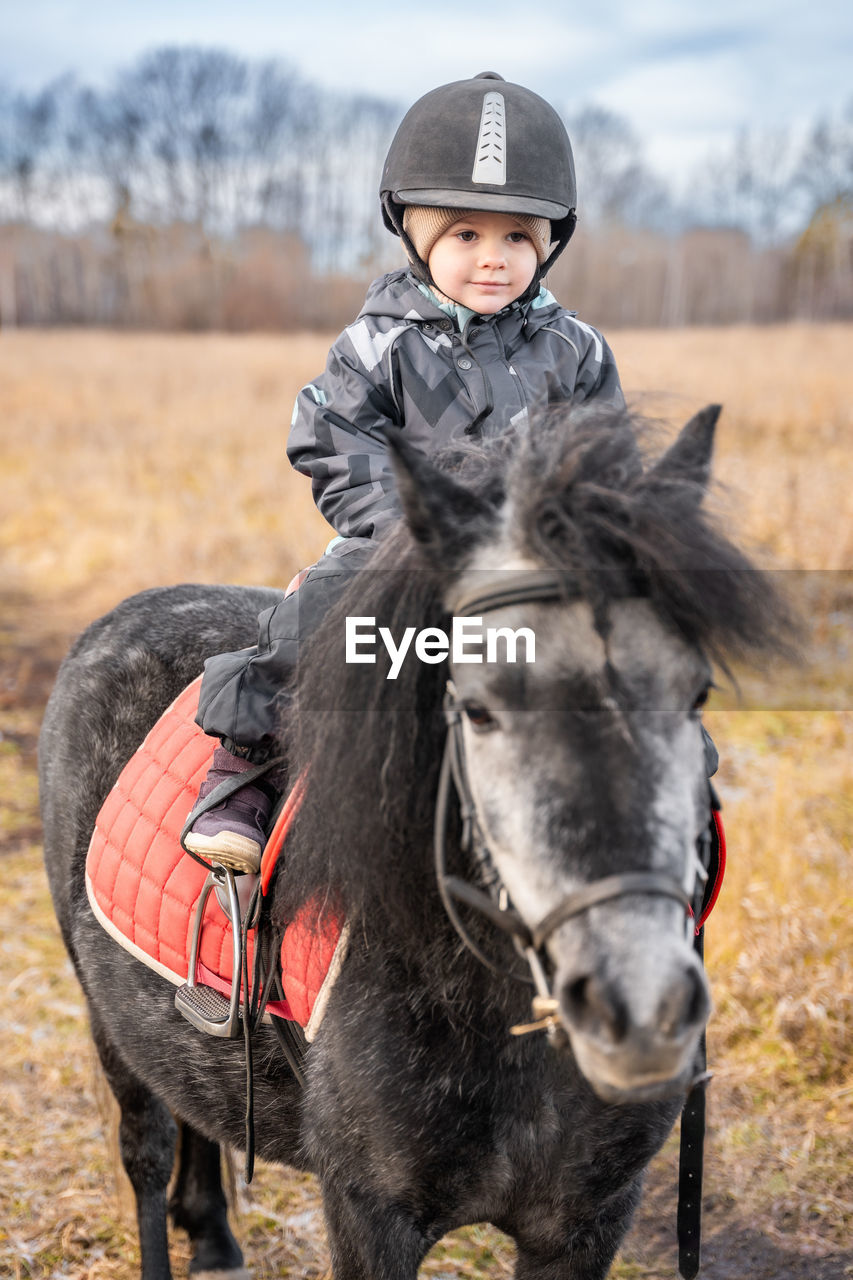 side view of man riding horse