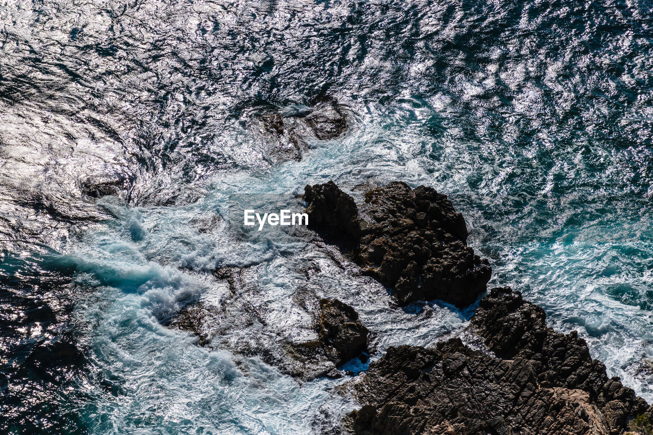 High angle view of rocks in sea