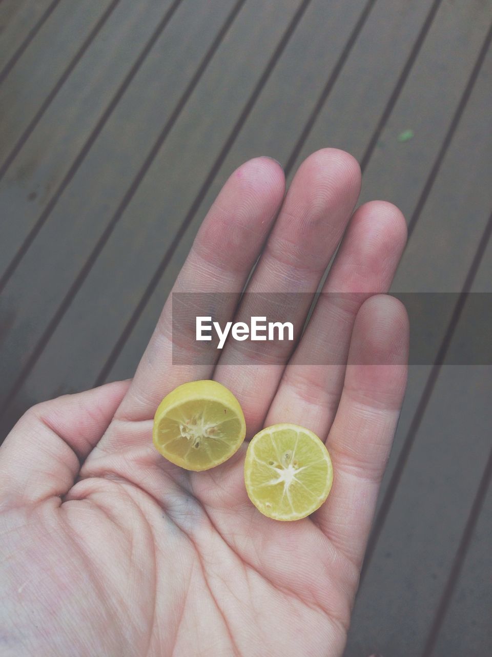 Hand holding slices of lime