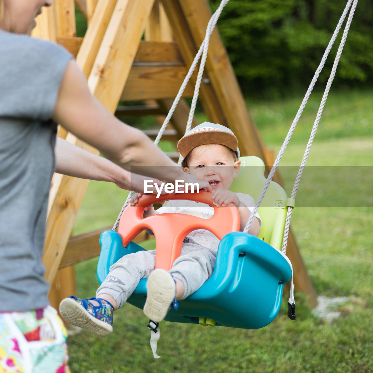 full length of boy sitting on slide