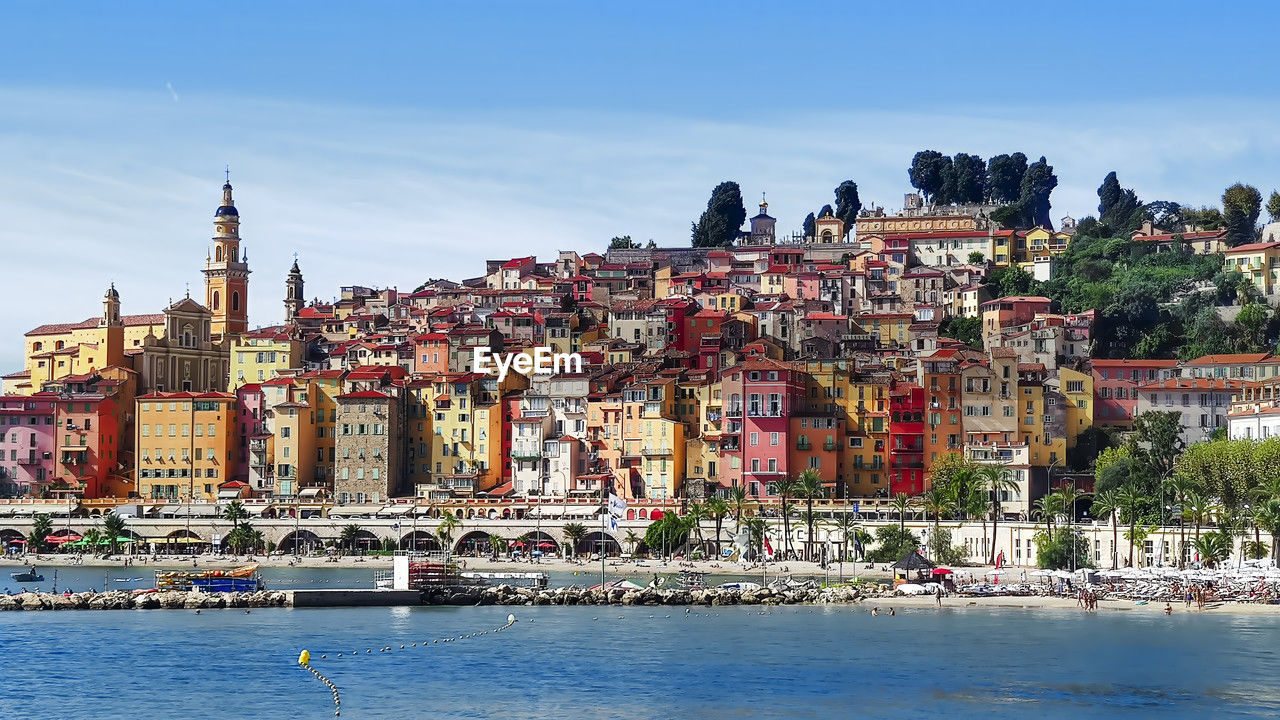 architecture, building exterior, water, city, built structure, town, cityscape, building, travel destinations, sky, vacation, travel, nature, tourism, sea, nautical vessel, coast, transportation, harbor, religion, waterfront, residential district, history, the past, no people, landscape, multi colored, landmark, house, outdoors, place of worship, mode of transportation, blue, land, trip, old, urban skyline, skyline, holiday, day, clear sky