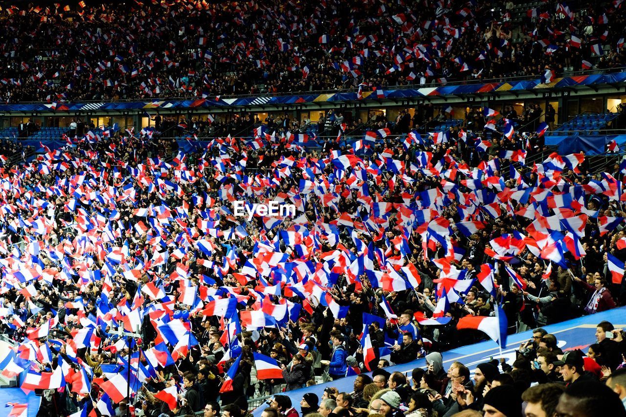 French audience with flags in soccer stadium