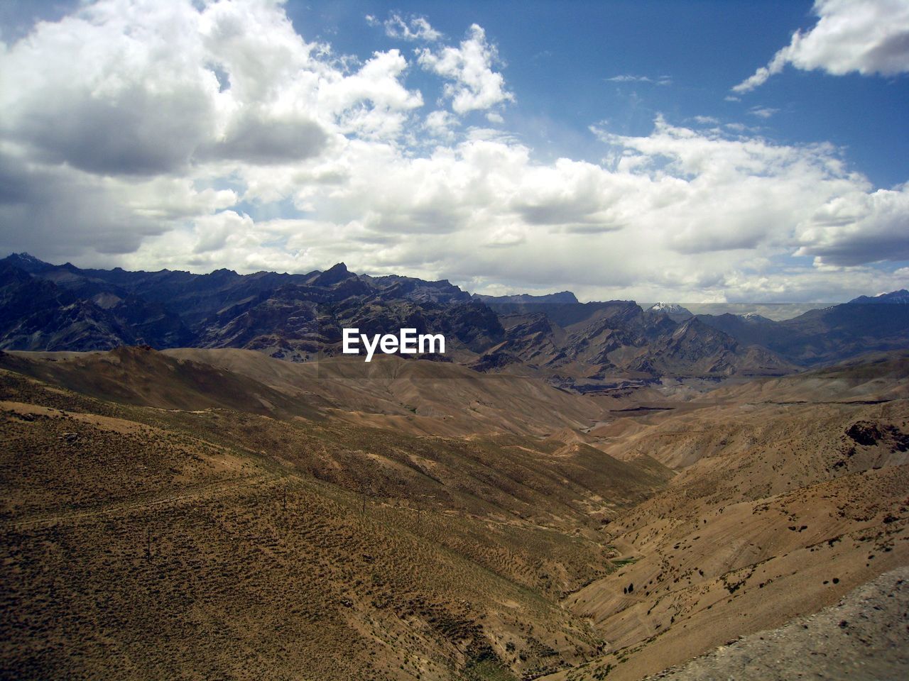 Scenic view of mountains against cloudy sky