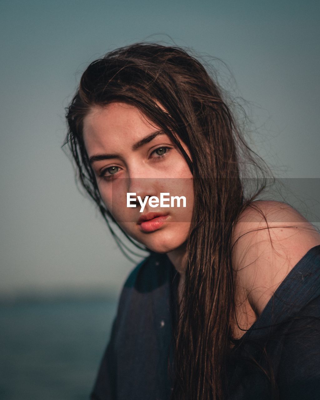 Portrait of beautiful woman against sky