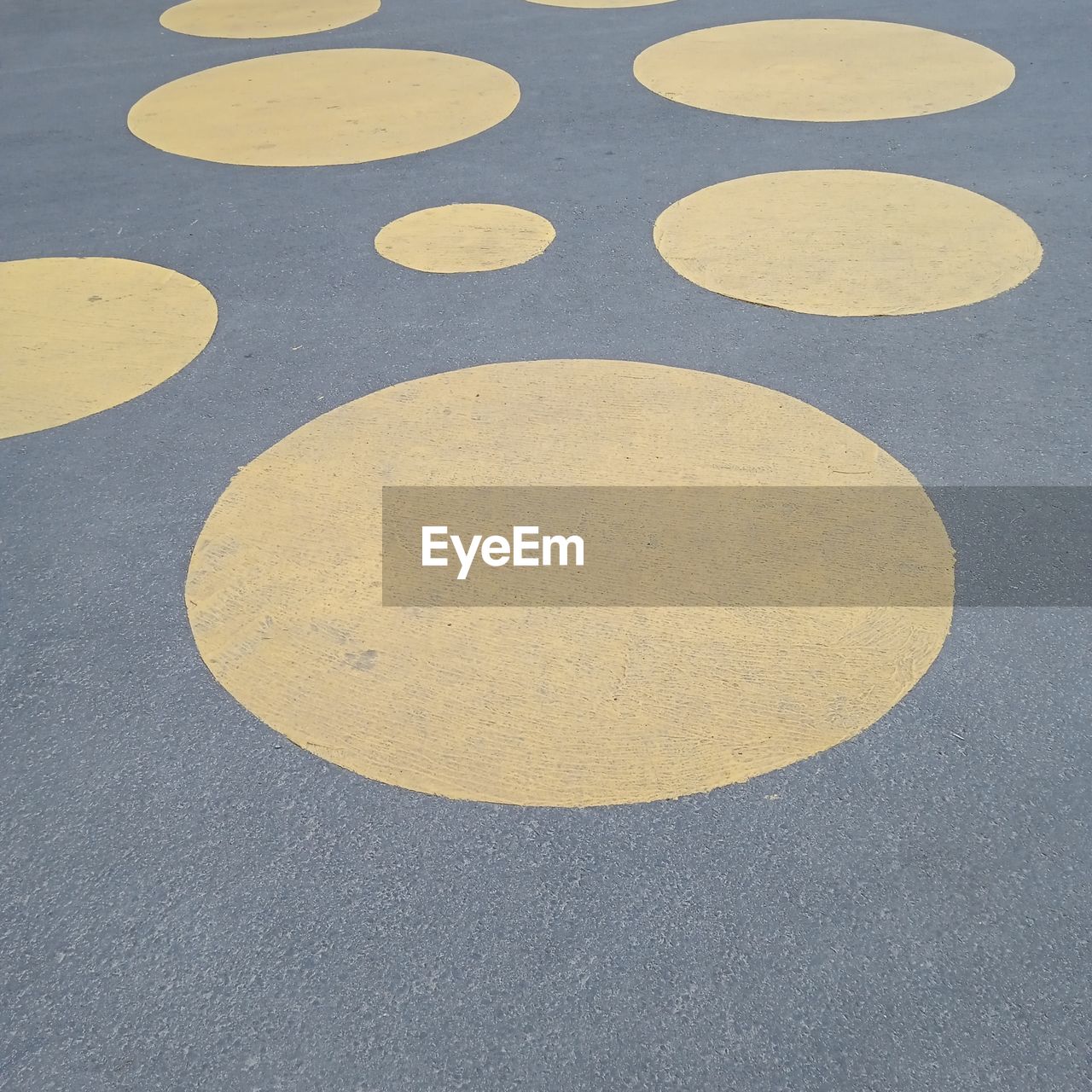 circle, floor, geometric shape, yellow, flooring, shape, no people, high angle view, road surface, asphalt, gray, number, close-up