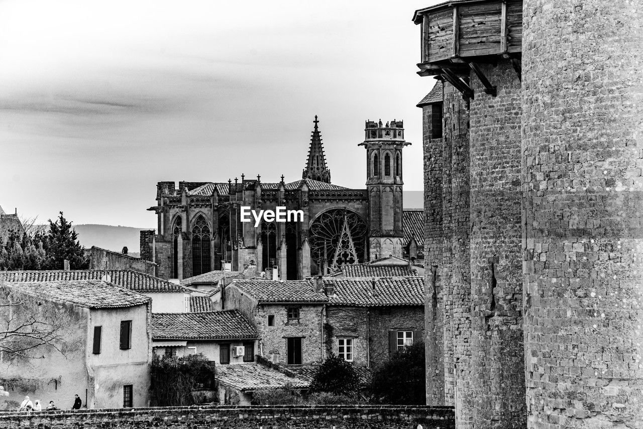 architecture, built structure, building exterior, black and white, building, history, monochrome, monochrome photography, sky, the past, religion, house, place of worship, nature, ruins, travel destinations, old, ancient history, no people, city, belief, spirituality, outdoors, day, travel, cloud, urban area, tower, tourism, residential district