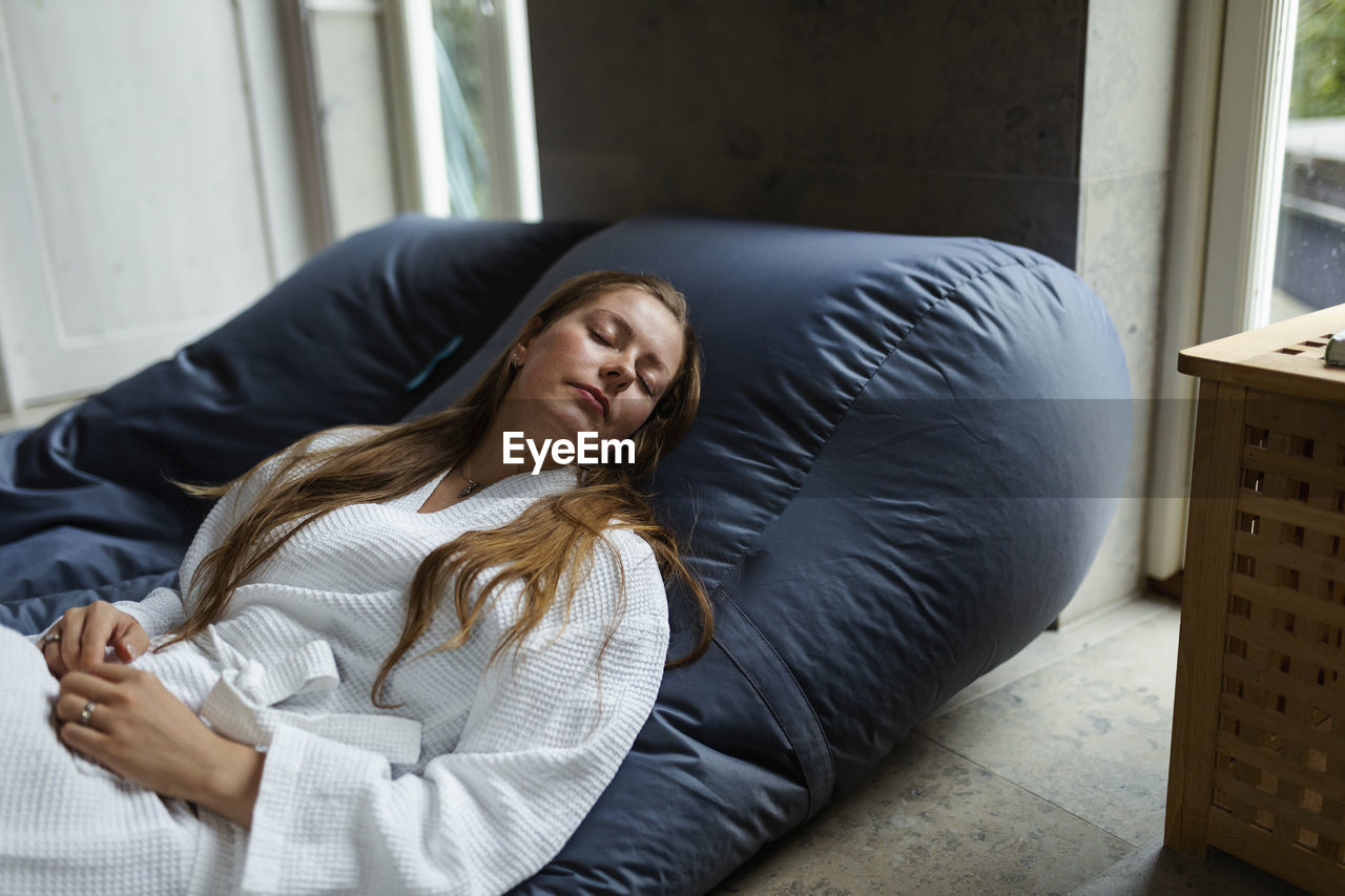 High angle view of woman relaxing on bean bag