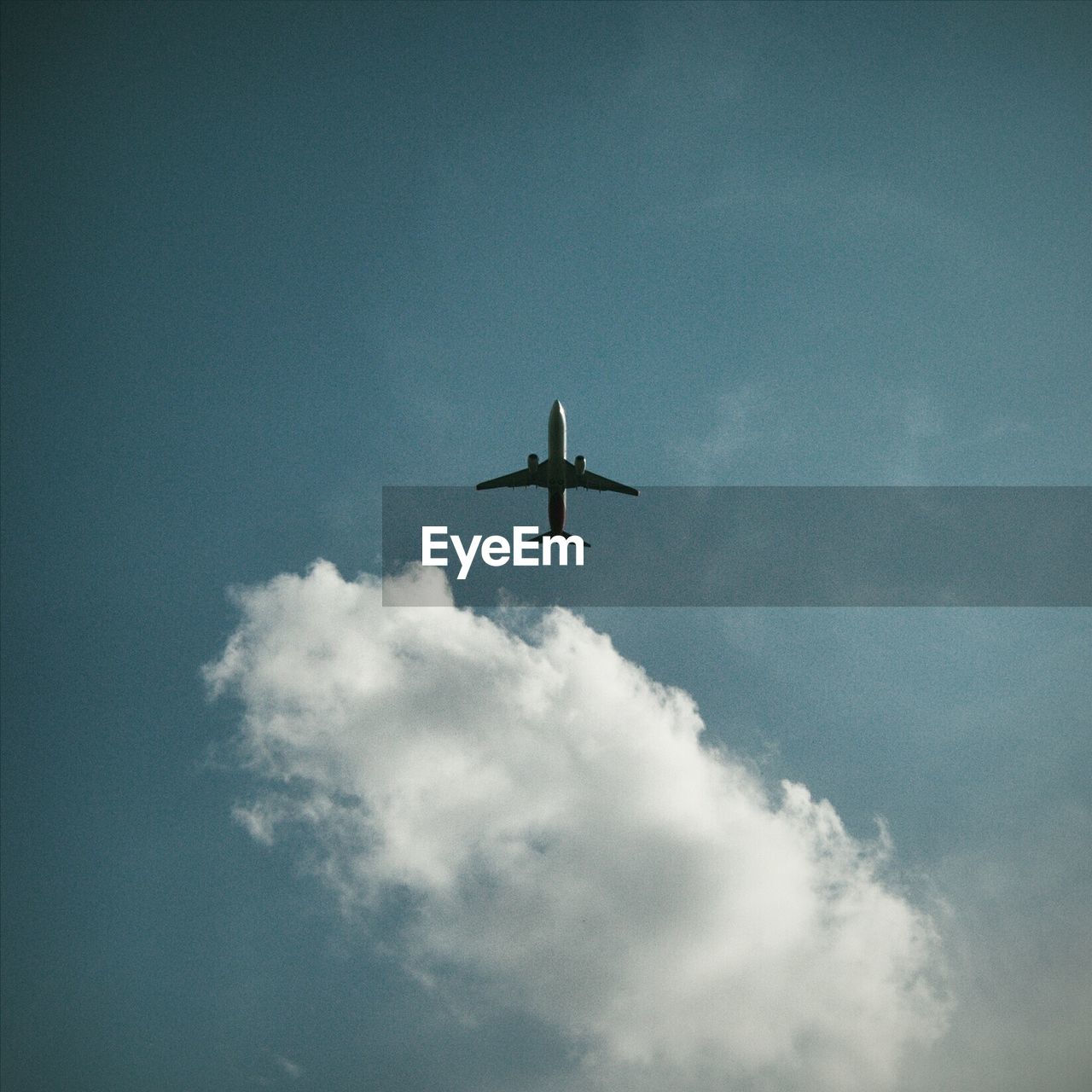 LOW ANGLE VIEW OF AIRPLANE IN SKY