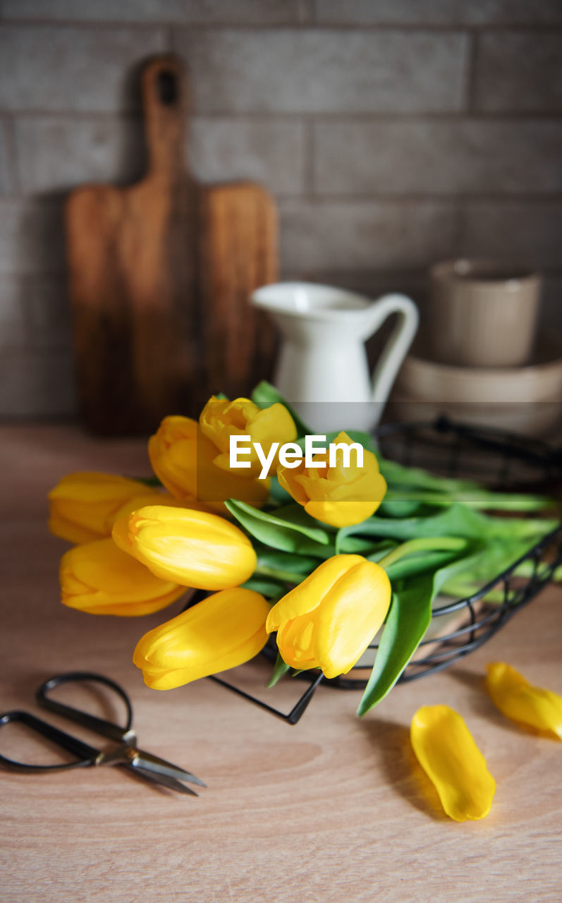 Beautiful yellow tulip flowers on table at kitchen