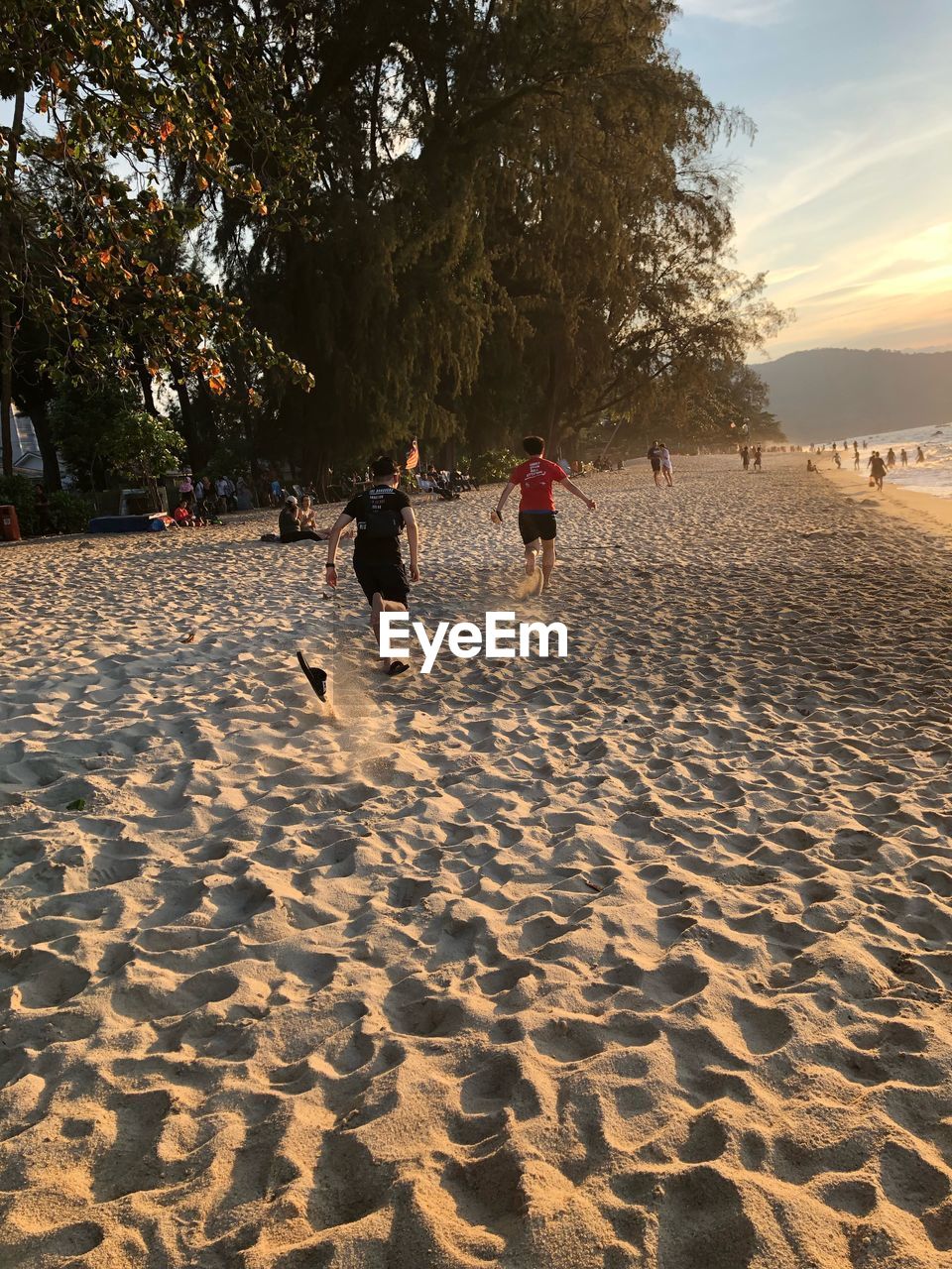 PEOPLE PLAYING AT BEACH