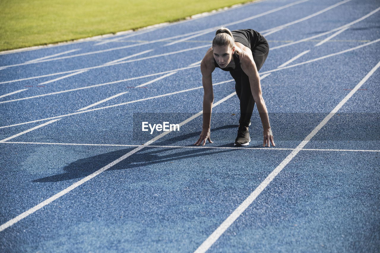 Young athlete at starting line of track