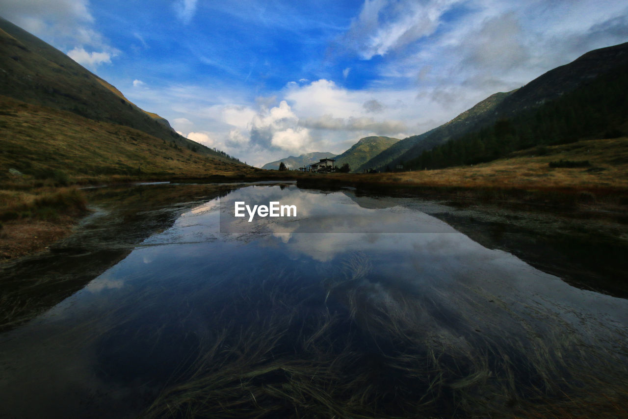 Scenic view of lake against cloudy sky