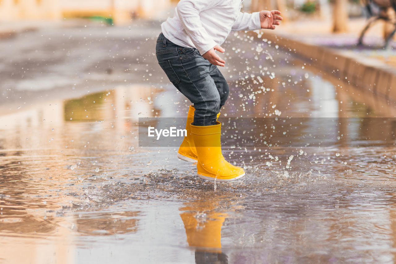 low section of man standing in water