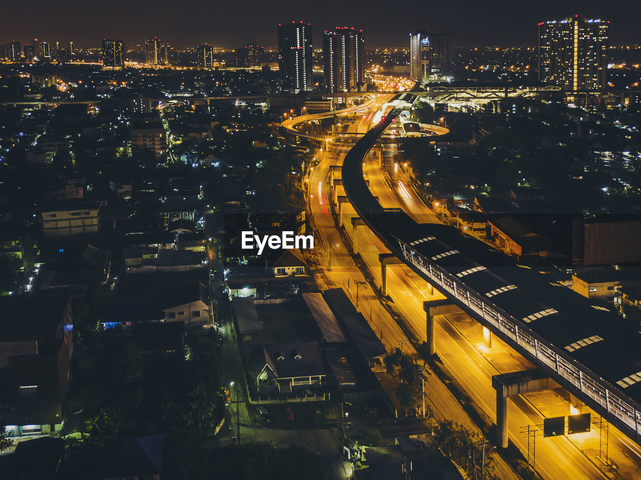 Illuminated cityscape against sky at night