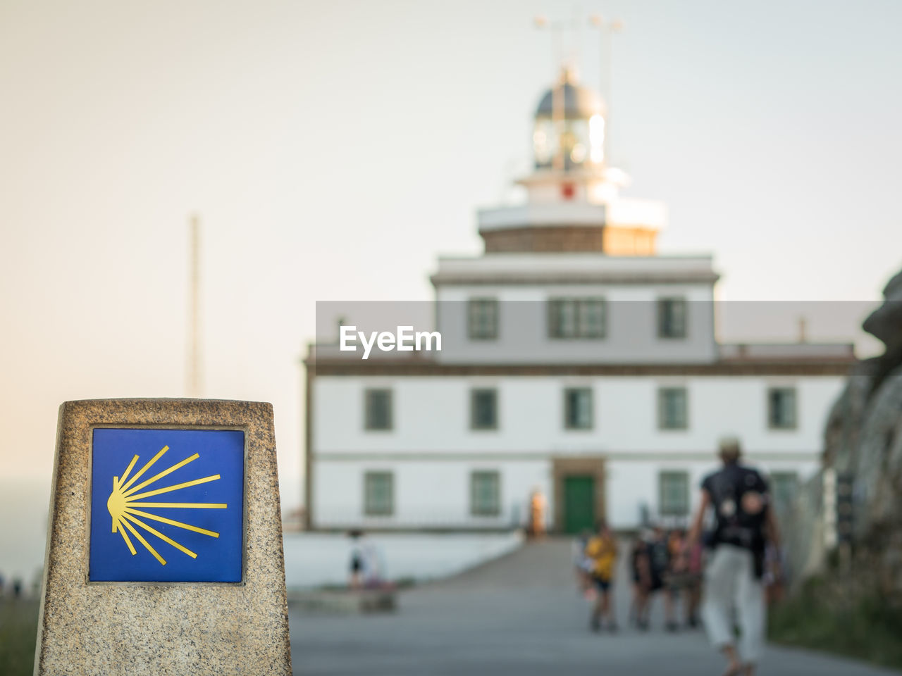 Marker of 0 km in santiago way in cape of finisterre with finisterre ligthouse in spain