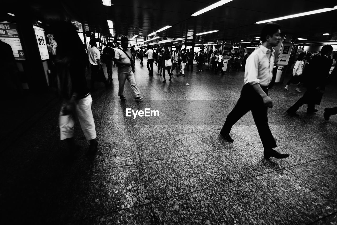 Commuters walking in subway station