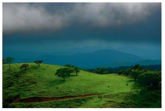 SCENIC VIEW OF MOUNTAINS AGAINST CLOUDY SKY