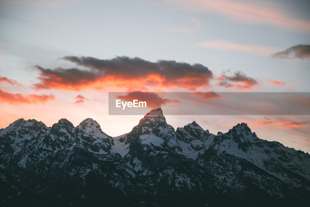 Scenic view of snowcapped mountains against sky during sunset