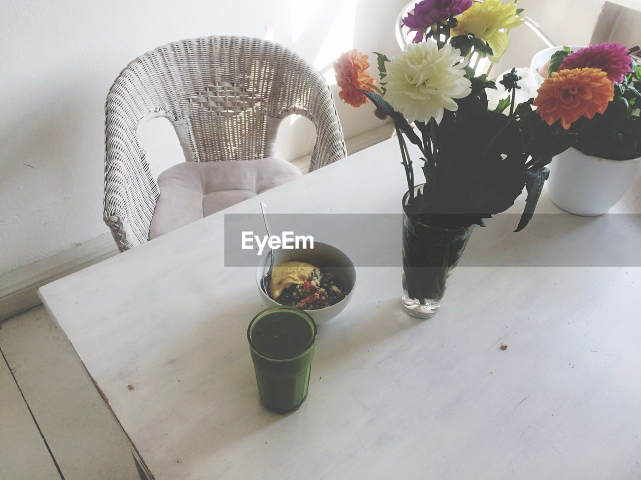 High angle view of breakfast by flower vase on table