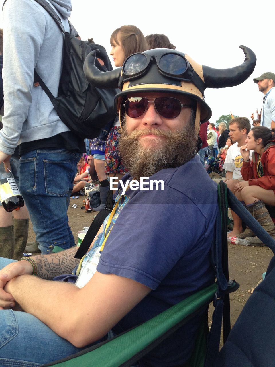 Portrait of smiling man in horn cap at music festival
