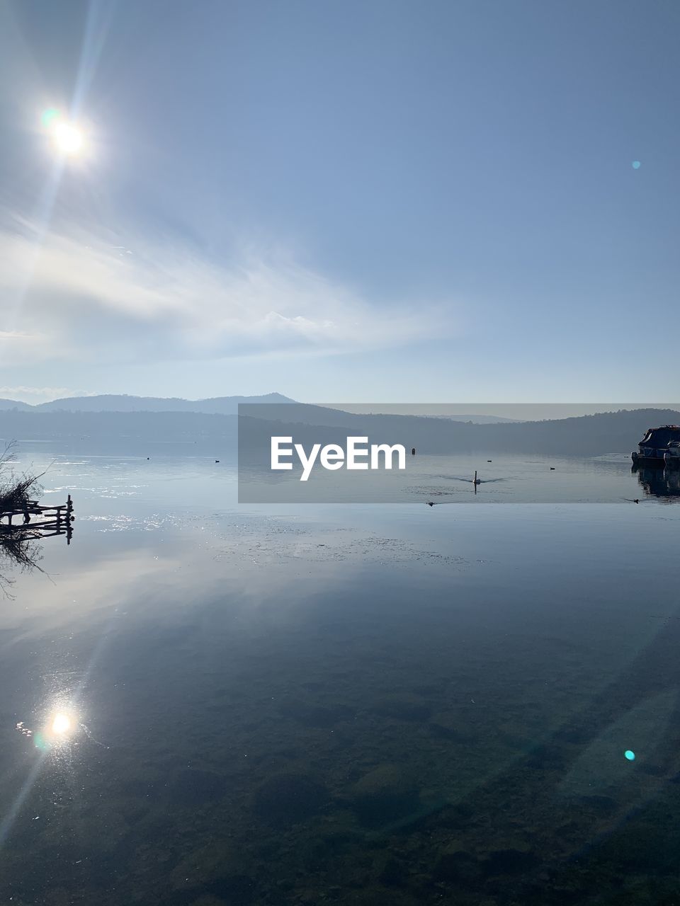 nature, sky, low angle view, light, outdoors, day, sunlight, beauty in nature, lens flare, water, no people, reflection, scenics - nature, transportation, cloud, sports