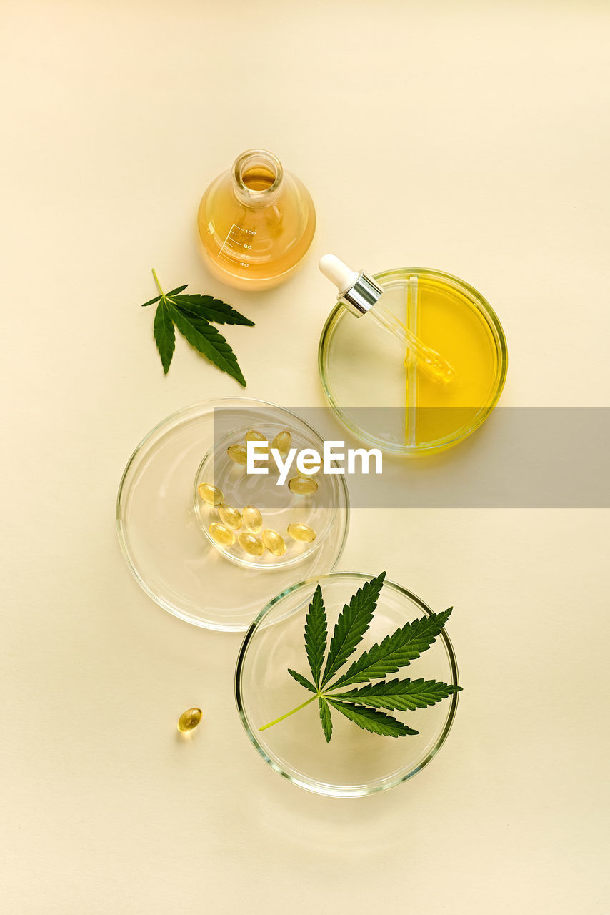 Products with cbd oil in laboratory glassware, concept of medical cannabidiol