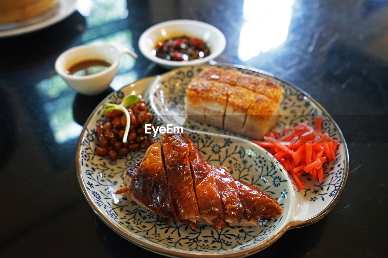 Close up crispy pork belly served with roasted barbecue duck- chinese food