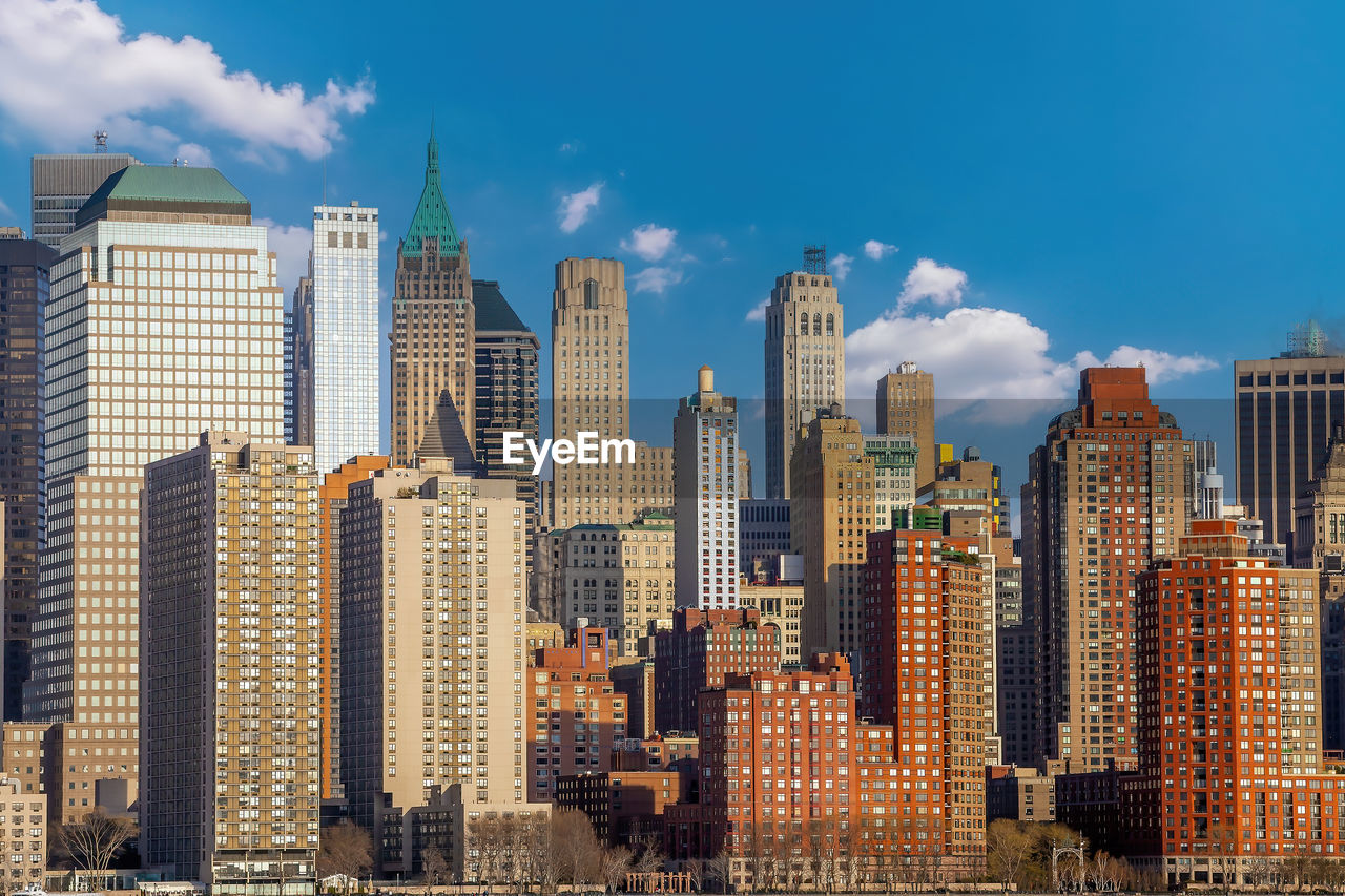 skyscrapers in city against blue sky