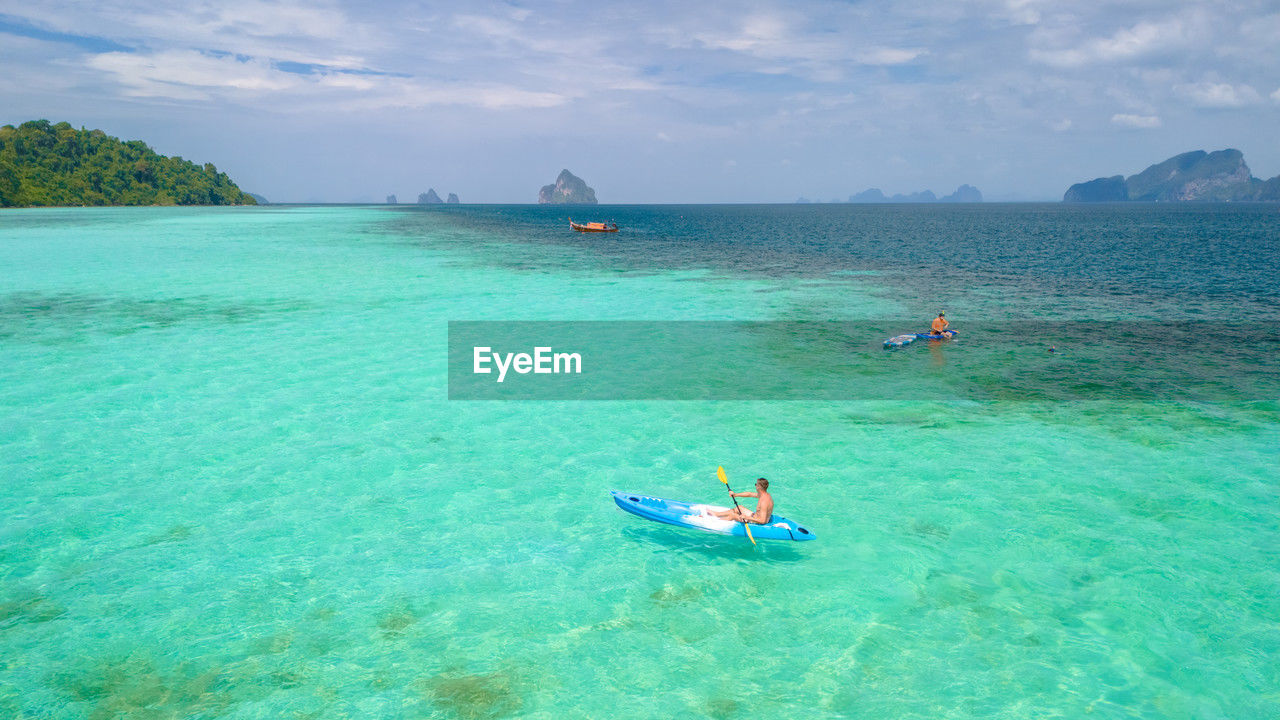 man kayaking in sea