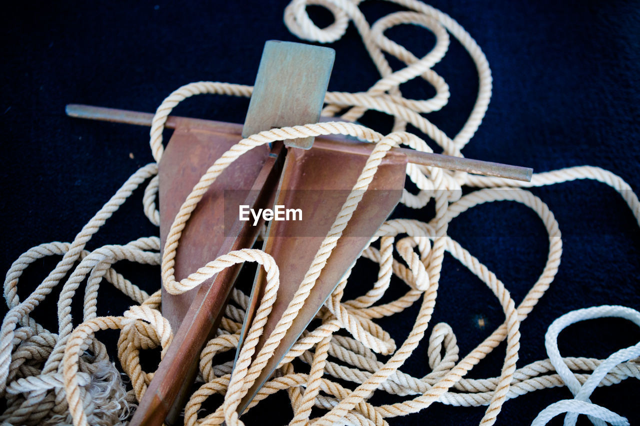 Close-up of tangled rope on cleat at boat deck