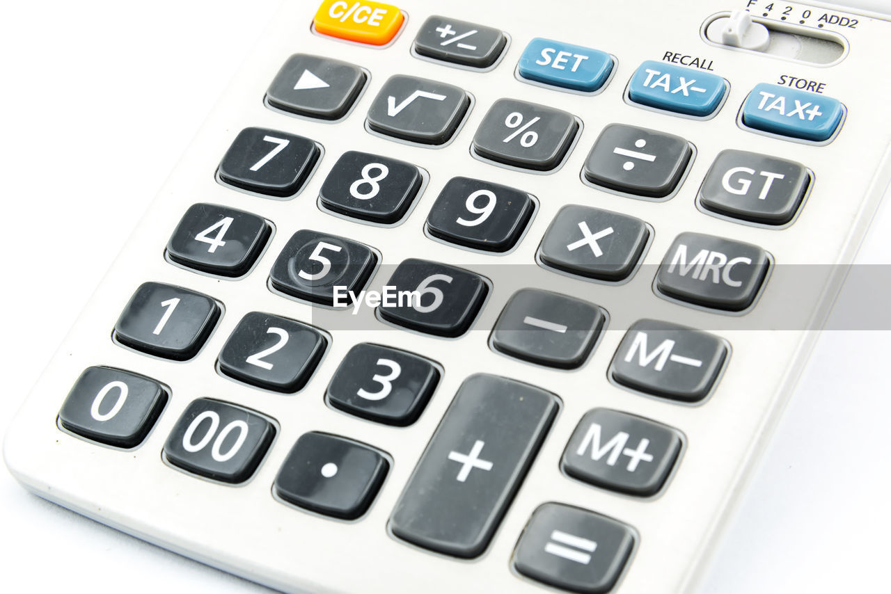 Close-up of calculator over white background