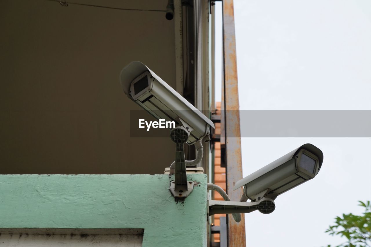 Close-up of telephone booth against sky