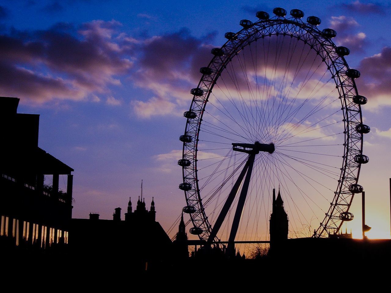 SILHOUETTE FERRIS WHEEL AT SUNSET