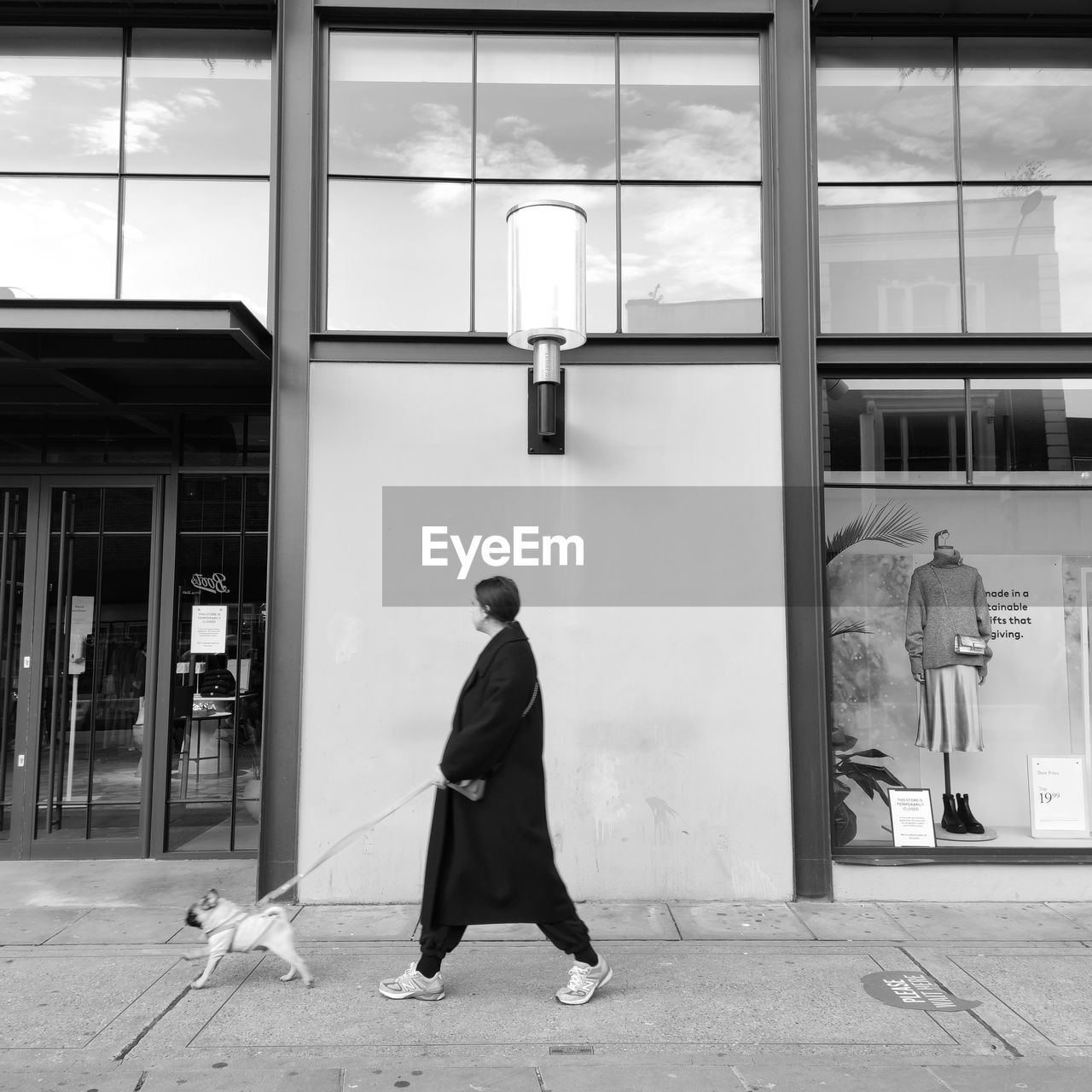 REAR VIEW OF MAN WALKING IN STREET