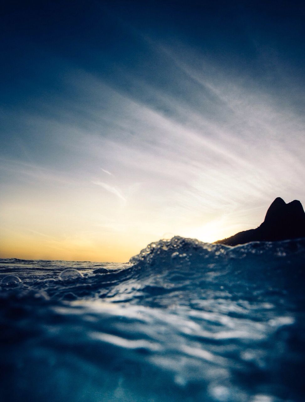 Surface level of calm sea against the sky