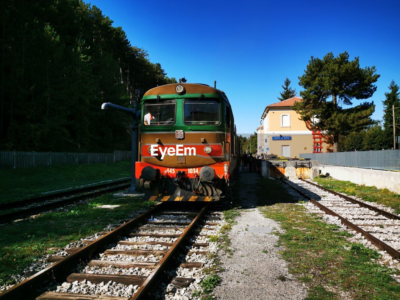 Train on railroad tracks against clear sky