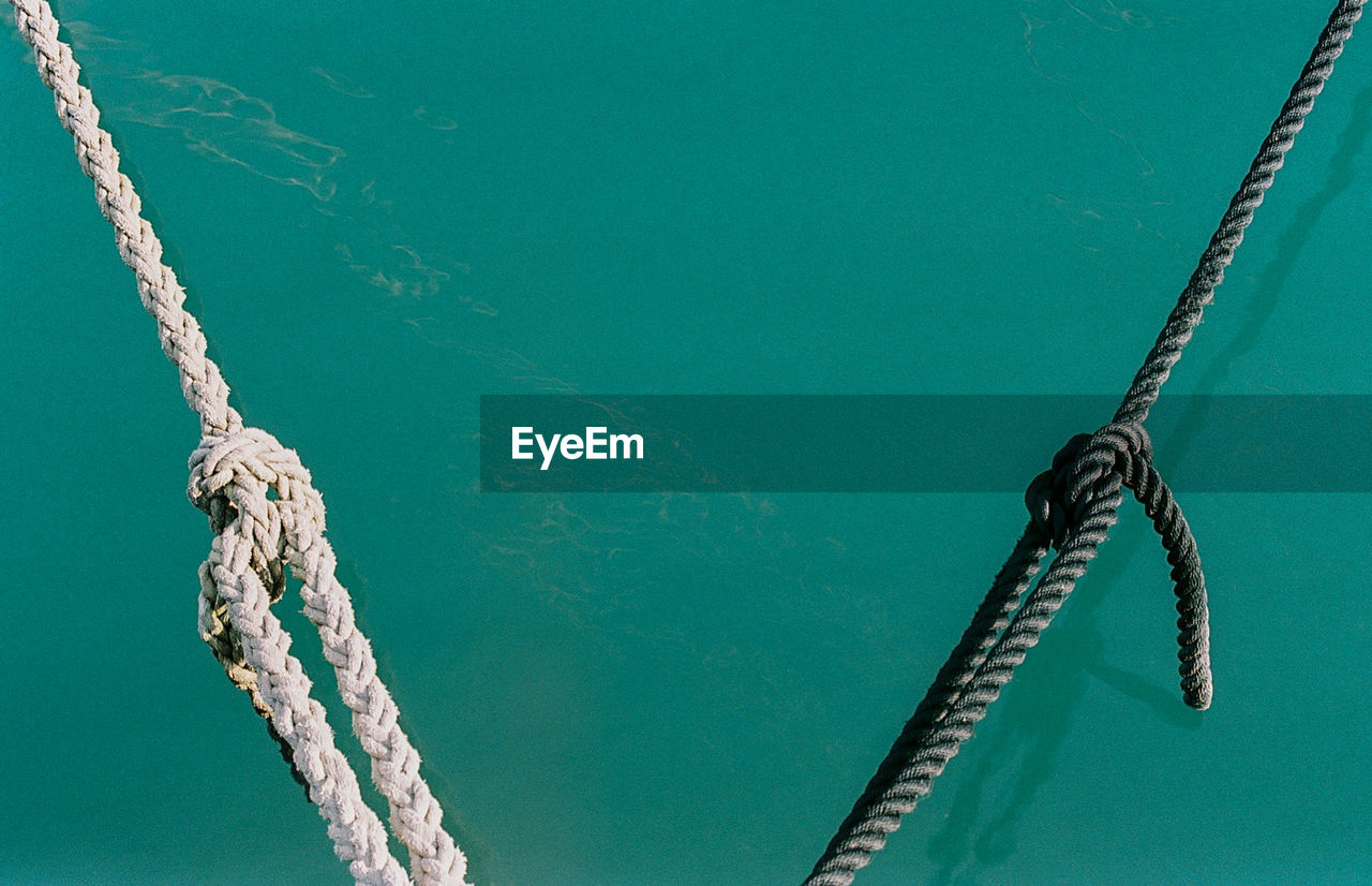 Low angle view of rope against sea