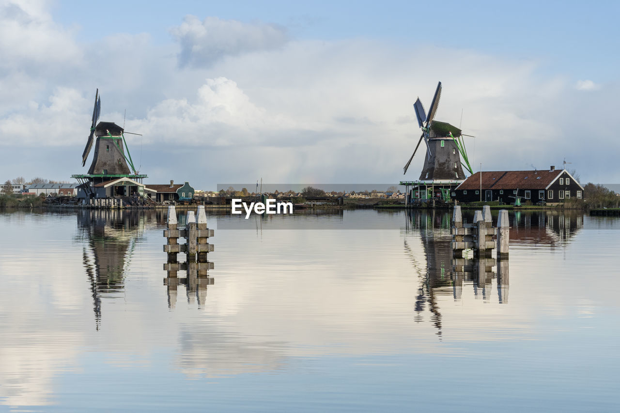 CRANES IN LAKE AGAINST BUILDING